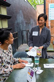 Volunteer ambassador talks with a diner