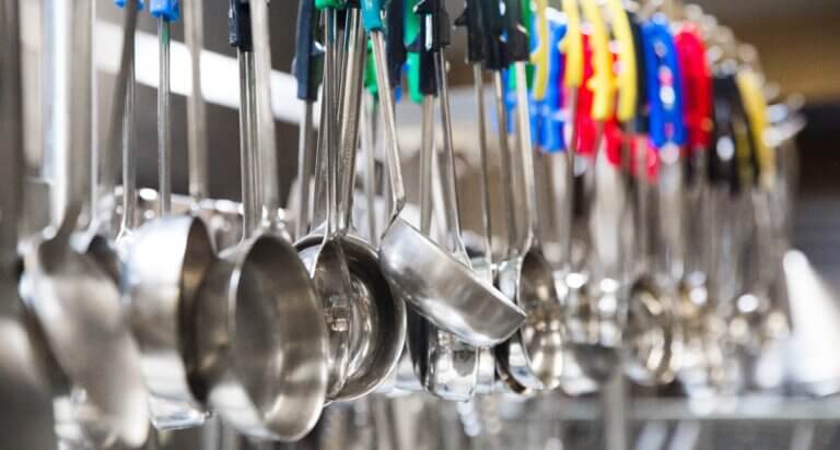 a row of ladles in the Project Angel Heart kitchen