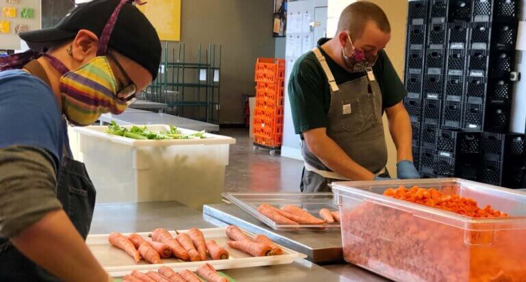 Project Angel Heart chefs wear masks while chopping carrots