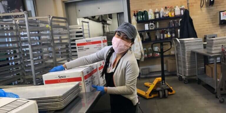 Project Angel Heart employee helping prepare meals during COVID-19