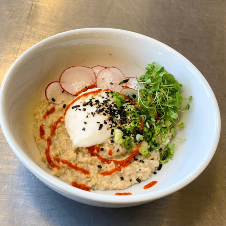 Bowl of savory miso oats with soft poached egg
