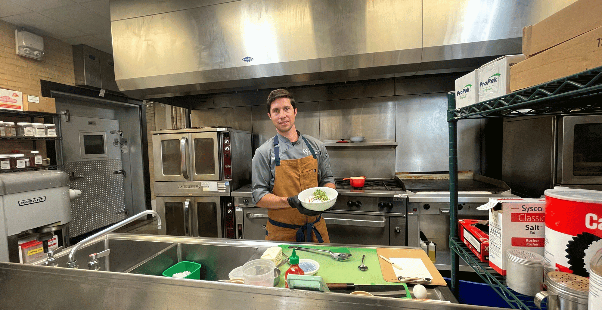 Cheff Brett holding a bowl of savory miso oats