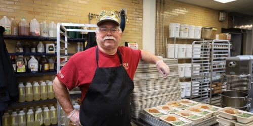 Jim with meals in the Project Angel Heart kitchen
